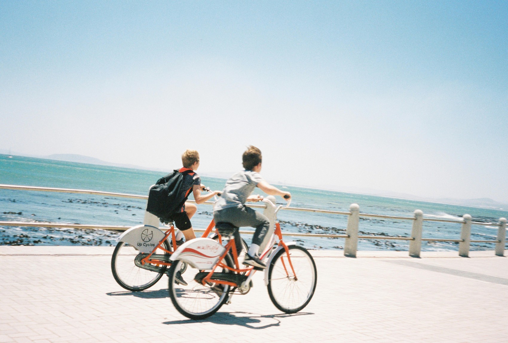Friends cycling along the Sea Point promenade